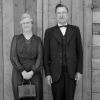 John and Etta Shuler posing in front of a wooden door