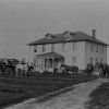 Cedar Lake Academy' dormitory building with Professor and Mrs. Lamson in the carriage with Nell. Adolf Evers and two of the boys driving the   greys   hitched to the Spring wagon. Irving Hall (now Dr. Hall) and Vinton Coskbam with the   Colts   attached to the wagon.