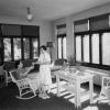 Hinsdale Sanitarium and Hospital patient receiving a drink while enjoying a sun room