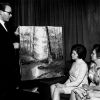 [Charles Brown showing the Art and Craft Show Committee one of the paintings to be displayed]