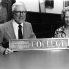 [Marley Soper and Louise Dederen standing with an old Emmanuel Missionary College sign in the Andrews University Heritage Room]