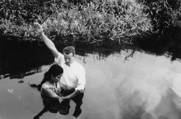Andrews University Theological Seminary 1955 graduate, Clinton Shankel, baptizes the first young lady convert in Palau, East Caroline Island.
