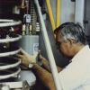[Elvin Vence, chief engineer, installing a new tube in the transmitter]