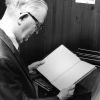 [Emmett Vande Vere reading one of the Pitcairn log books in the Andrews Univeristy Heritage Room]