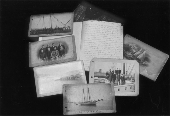 [Pictures and log books related to Pitcairn Island displayed in the Andrews University Heritage Room]