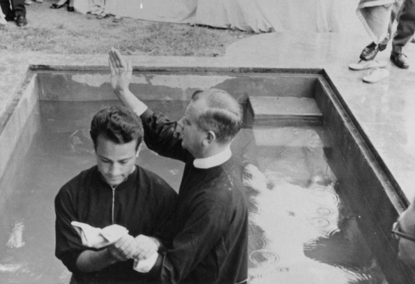 Andrews University Theological Seminary student, Kenneth Harding, baptizes a Muslim student in Iran