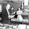 [Richard Powell, Larry Bergstrom, and Donna Stout looking over the book display at the James White Library]