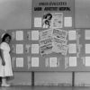 [Two unknown nurses standing by a bulletin board at Saigon Adventist Hospital]