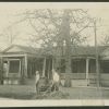 Front of the old Madison Sanitarium with two students working on the grounds and an unknown nurse