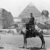 [Louis B. Reynolds riding a camel in front of the Great Sphinx and Pyramid of Khafre in Giza, Egypt]
