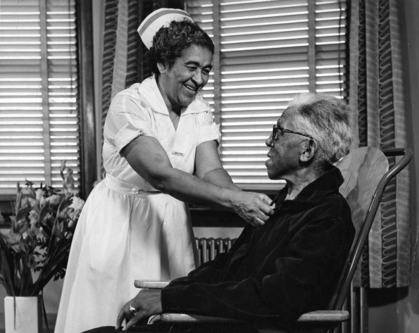 [Edna L. Ford nursing an elderly man in the Riverside Sanitarium, Nashville, TN]