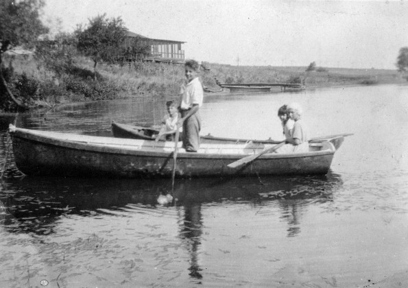 [Mary Kate Gafford and unknown friends boating on a lake]