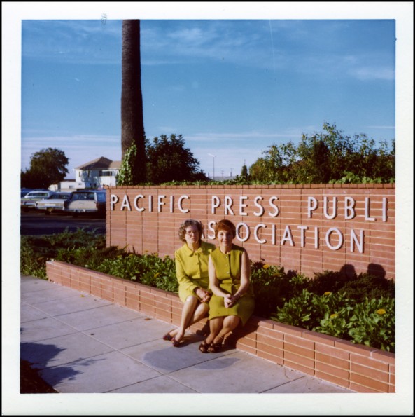 Virginia Kilpper and Jeanne Christiansen in front of the Pacific Press sign