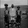 Christian native flanked by Kisii tribesmen