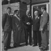 E. A. Sutherland posing with four unknown men at the opening of the Madison branch of the First American National Bank