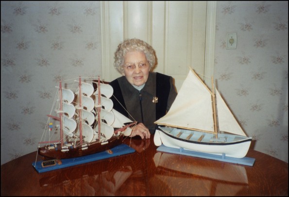 Verda Belle Spaulding with models of the HMS Bounty and native longboat, made by Floyd McCoy