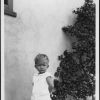 William Brunie aged 19 months posing by plant