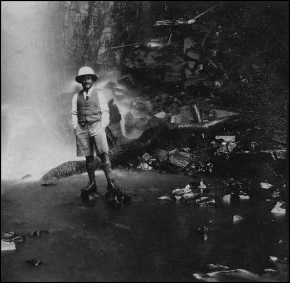 Eric Beavon standing in front of a waterfall