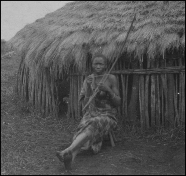 Kisii native sitting in front of hut