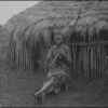 Kisii native sitting in front of hut