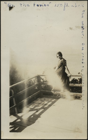 Ruth Greer posing on the fence at Mackinac Island
