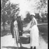 [Yolanda Sutherland with unknown Thelma holding a basket of linen at Madison College]