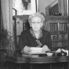 Bessie DeGraw sitting at a desk