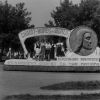 Front view with 5 unknown women of a Labor Day parade float entered by seventeen Seventh-day Adventist churches in the Detroit, Michigan, vicinity in 1954