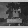 Four Madison ladies standing on the sign for Ravens Roost parking overlook