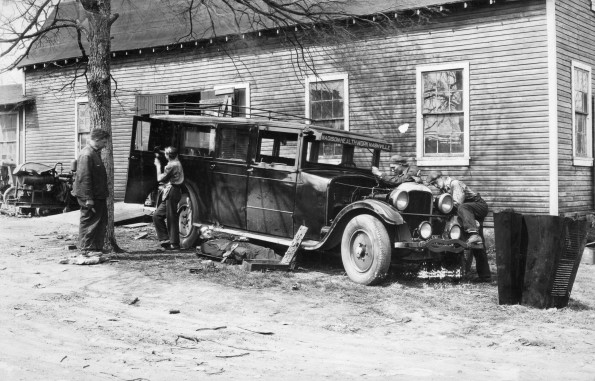 [Unknown people working on the Madison College school bus at the Machine and Repair Shop
