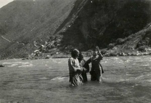 Picture of baptism outside in river.