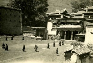 Monks standing in courtyard of temple.