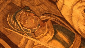Detail from tapestry found at the Center for Adventist Research. It is a close-up of a man in armor looking up intently.