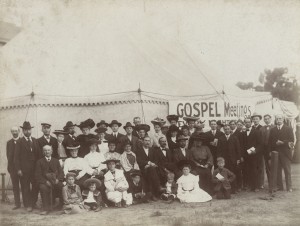 Simpson and others in front of a tent used for meetings.