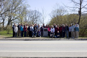 Group photograph of participants with the historical marker designating Gorham, Maine as the birthplace of Ellen White.