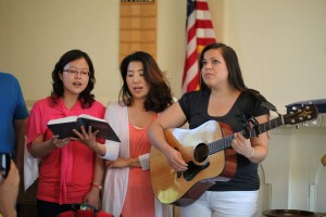 Suh Young Shin, Shin Ju Kim, and Mariesa Tinkham sing, "When He Cometh," at the Roosevelt Seventh-day Adventist Church.