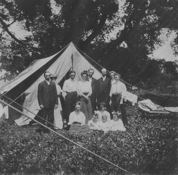 Family group outside their tent at the Michigan Conference camp meeting, about 1909