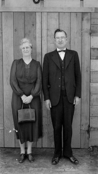 John and Etta Shuler posing in front of a wooden door