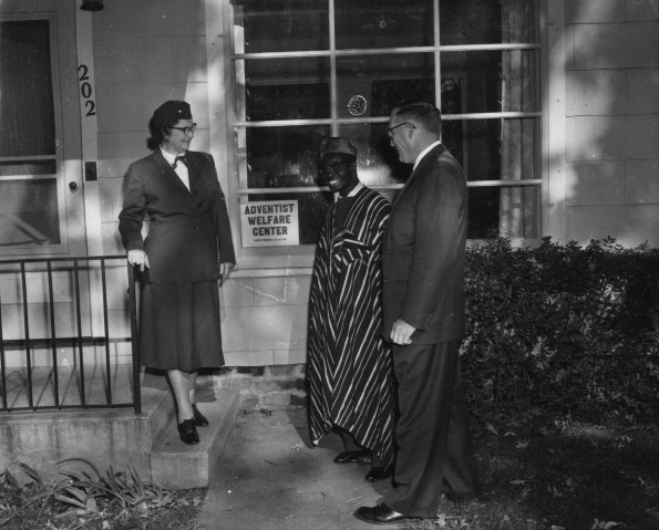 Dorcas Welfare Society providing clothing to a new-comer to town