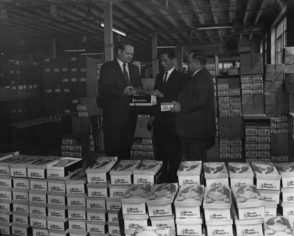 Seventh-day Adventist Community Services officials acepting donation of a large quanity of Hush Puppies shoes