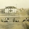 Cedar Lake Academy general campus view with a dormitory and farm buildings, 1916-1917