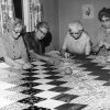 Quilt top number 100 is almost completed by (left to right) Mrs. Gladys Schmidt, Bertha K. Wohlers, Mrs. Ivah Wilson, and Mrs. Elsie Leffler at the Berrien Springs Springs Community Services Center