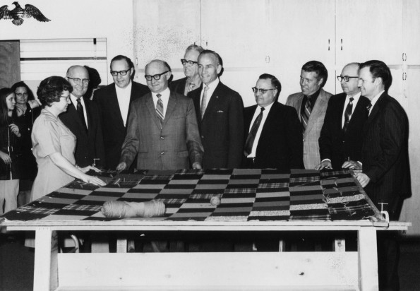 Berrien Springs Community Services Center Director, Elizabeth Schoun, shows a quilt under construction during the grand opening of the Center