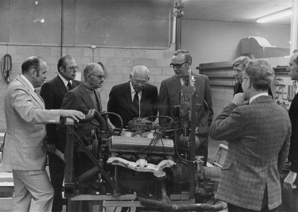 Loma Linda University President, V Norskov Olsen and some men tour a machinery shop, 1970s