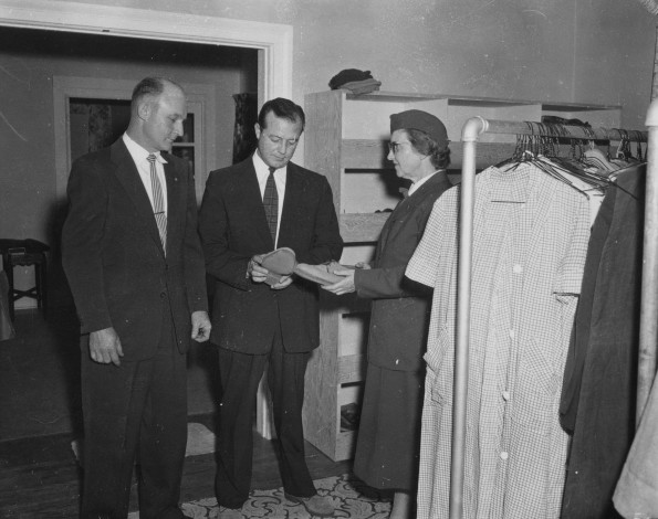 Seventh-day Adventist Community Services volunteer displays shoes and clothes to be given to those people in need