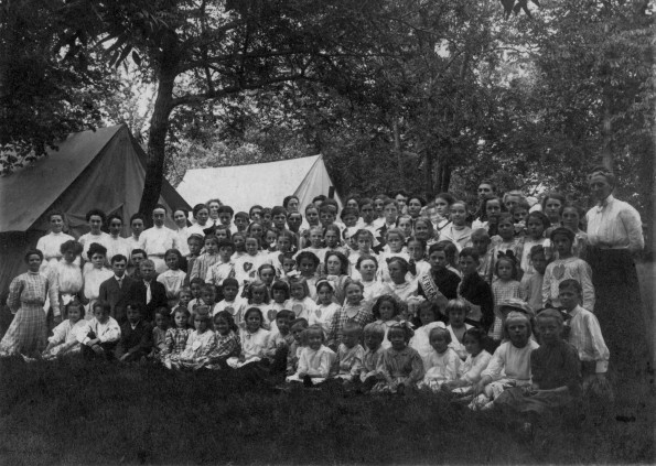 Verne Kelsey wear an African banner at Minnesota camp meeting