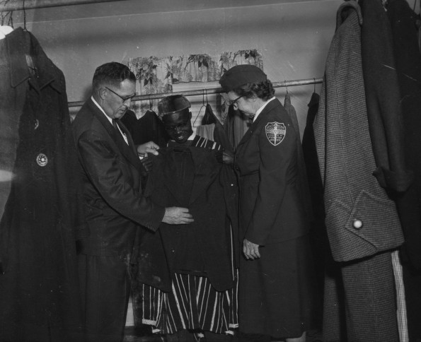 Dorcas Welfare Society providing clothing to a new-comer to town