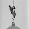 Unknown man climbing a flagpole