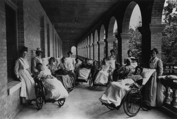 Battle Creek Sanitarium patients in wheelchairs on a covered portico