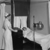 Hinsdale Sanitarium and Hospital patient getting ready for a treatment from her nurse